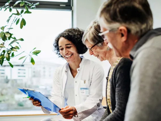 doctor and patients looking at clipboard