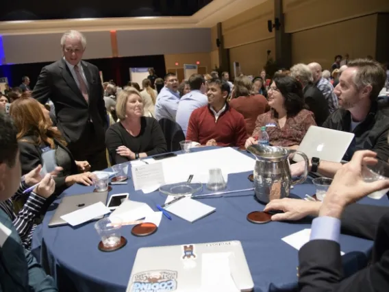 Dr. Robbins speaks with participants at strategic planning forum