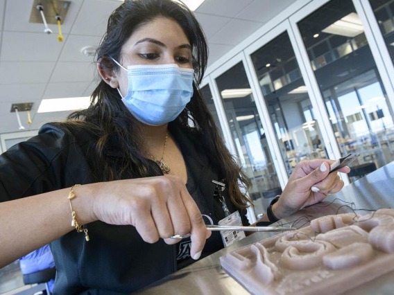 A student practices clinical skills in ASTEC.