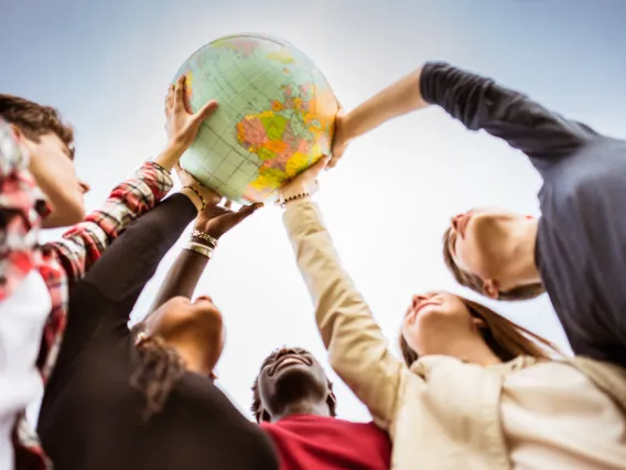 Students holding globe