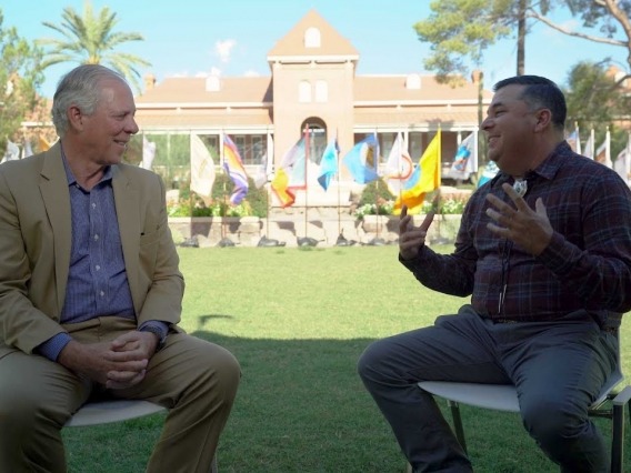 President Robbins and Levi Esquerra talk on the UArizona Mall
